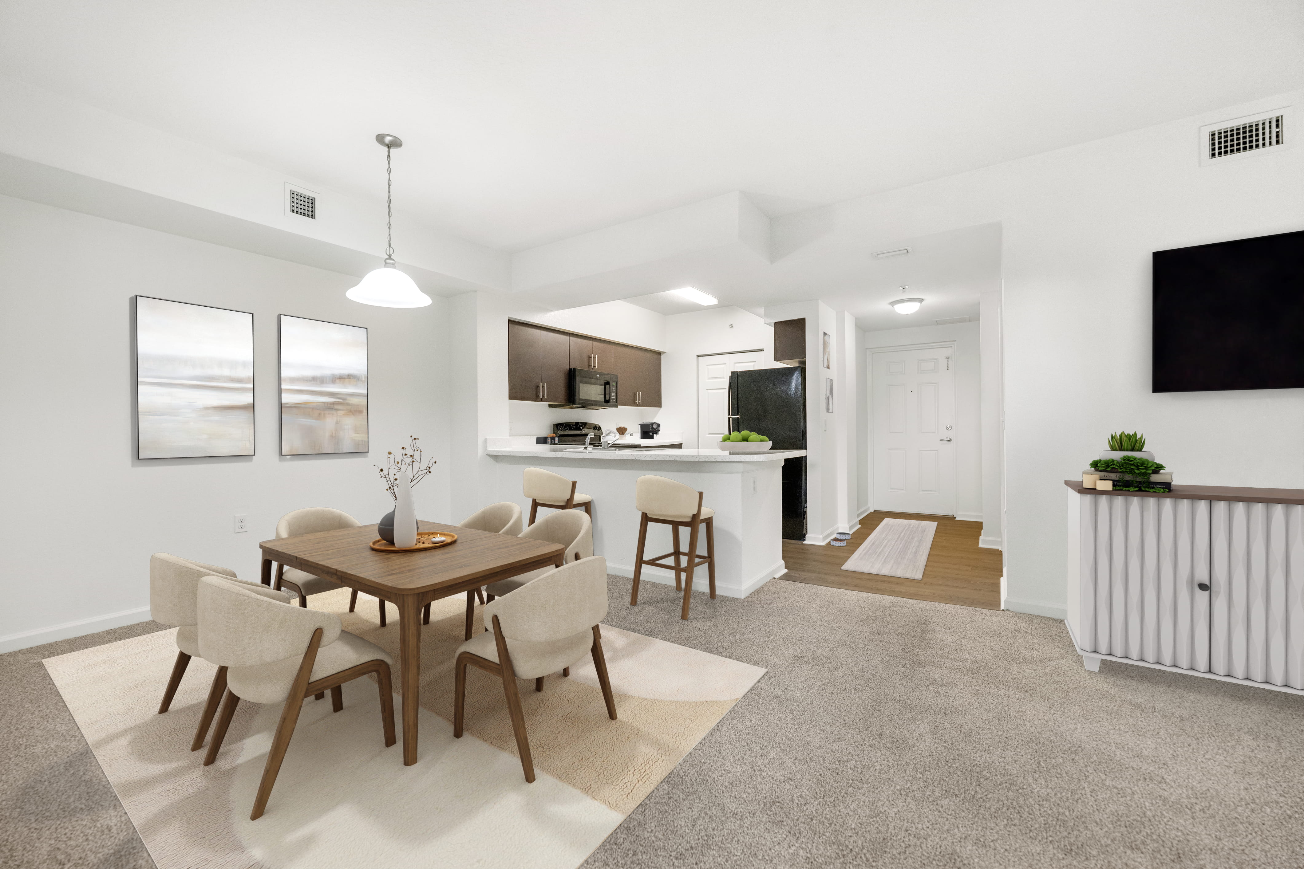A modern dining room with a wooden table and chairs.